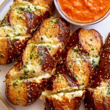 a close up of disneyland's famous cheesy garlic pretzel bread from maurice's treats.