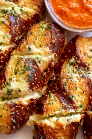 a close up of disneyland's famous cheesy garlic pretzel bread from maurice's treats.