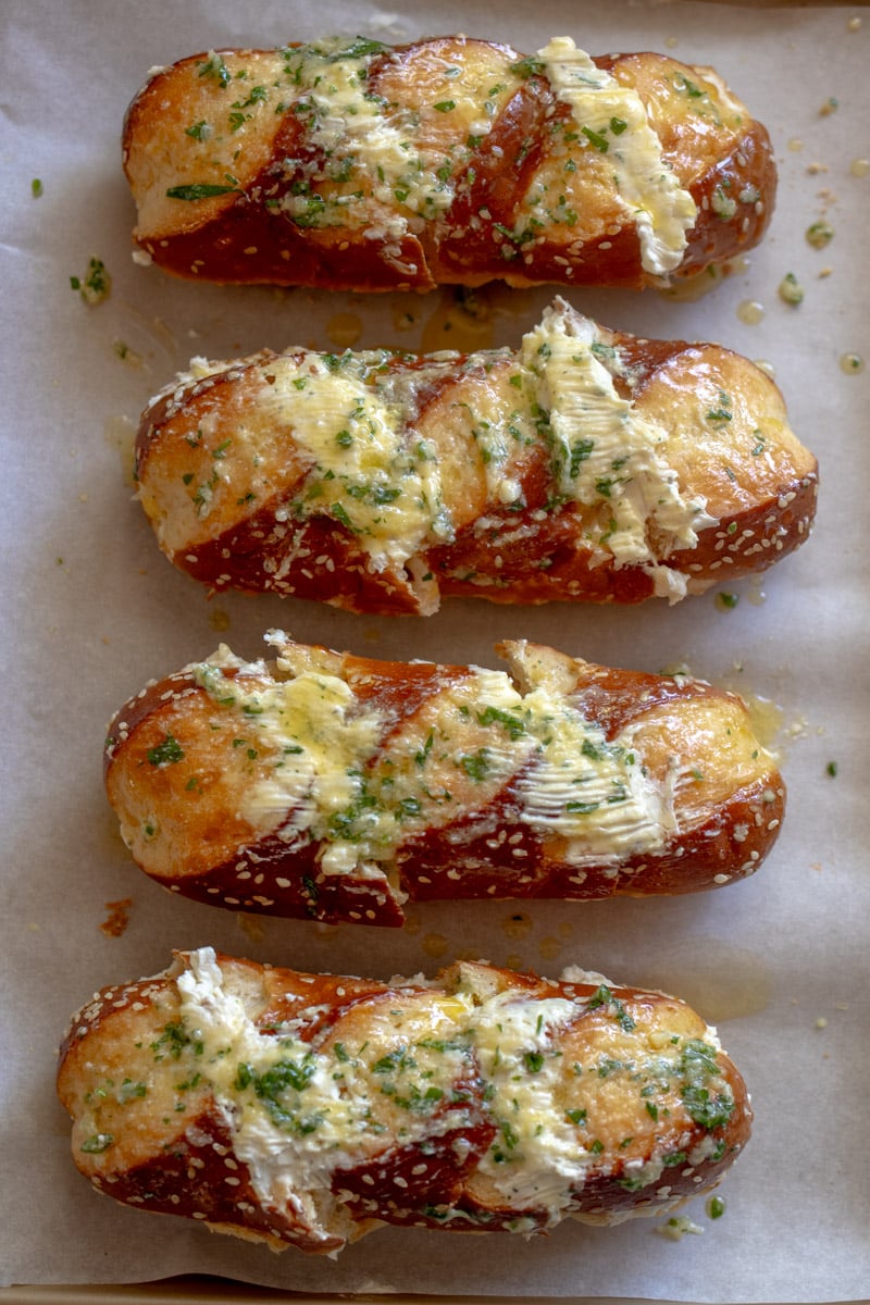 unbaked cheesy garlic pretzel bread on a baking sheet.