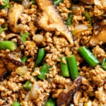 an up close look at the texture of this ground pork stir fry with green beans, mushrooms and onions and asian sauce.