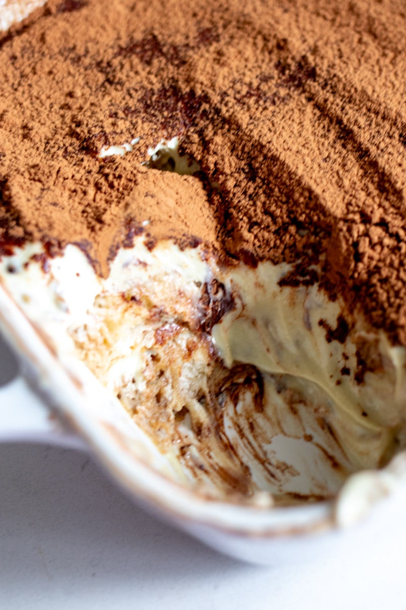 a few scoops taken out of a pistachio tiramisu.