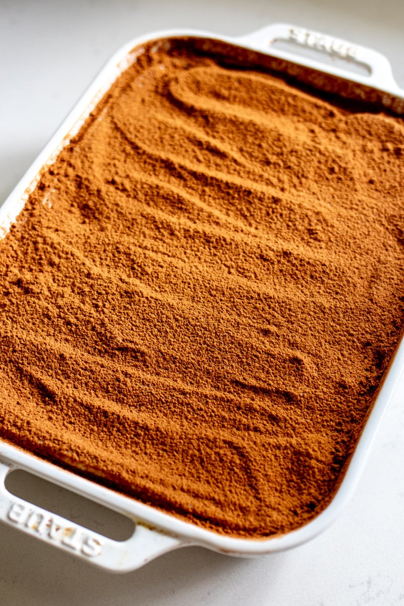 an overhead view of a baking dish filled with pistachio tiramisu.