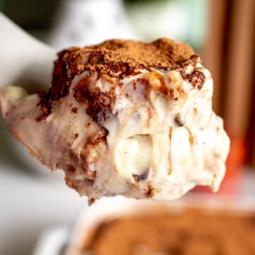 a spoon holding a scoop of pistachio tiramisu.