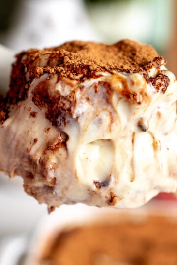 a spoon holding a scoop of pistachio tiramisu.
