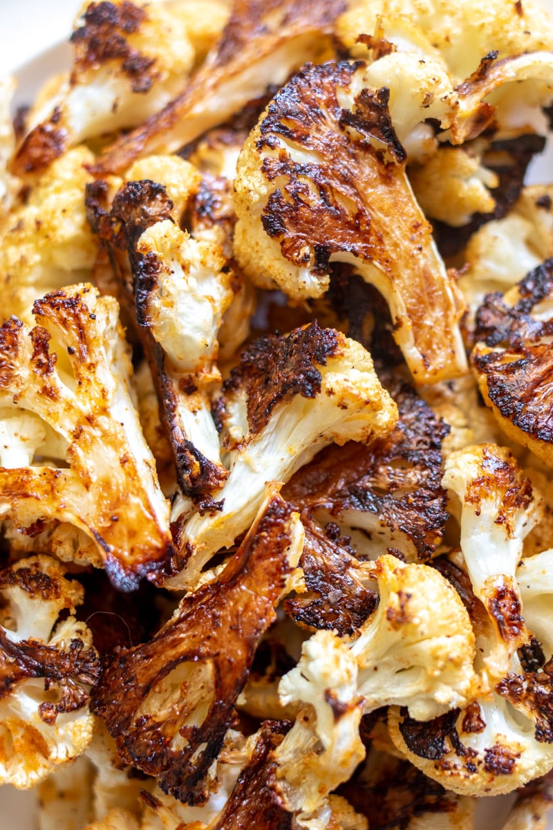 a close up of the texture of crispy roasted cauliflower with its golden edges.