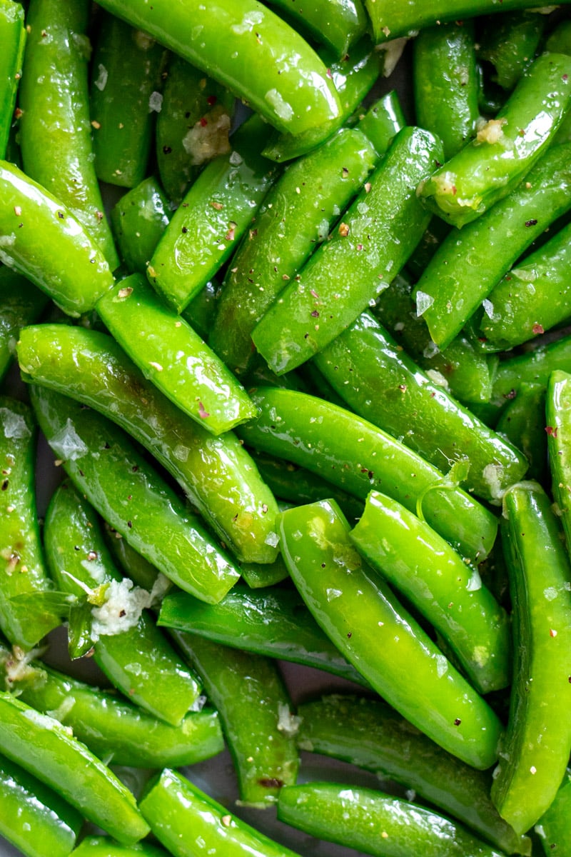 an up close view of bright green Sautéed Sugar Snap Peas.