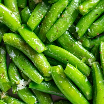 an up close view of bright green Sautéed Sugar Snap Peas.