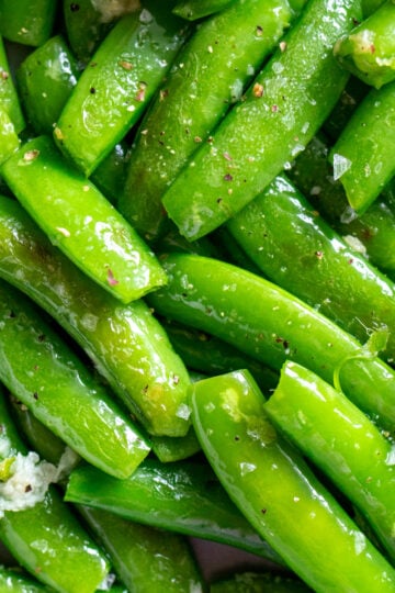 an up close view of bright green Sautéed Sugar Snap Peas.