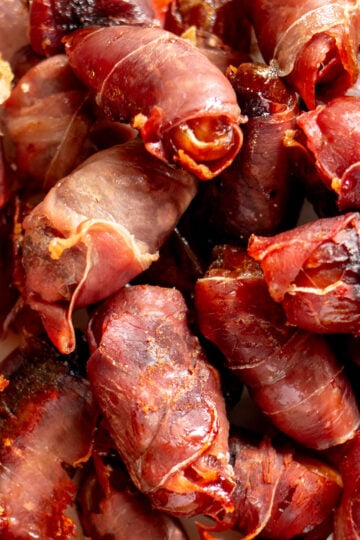 an up close look at a bunch of crispy prosciutto wrapped dates.