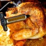 a beautiful golden brown turkey being injected with a flavorful butter mixture.
