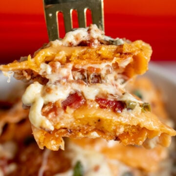 a fork holding a scoop of butternut squash lasagna.