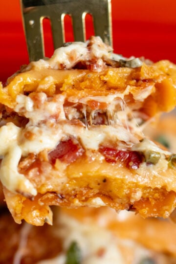 a fork holding a scoop of butternut squash lasagna.