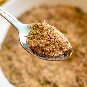 a silver spoon holding a scoop of turkey seasoning.