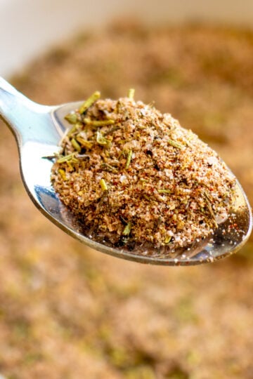 a silver spoon holding a scoop of turkey seasoning.
