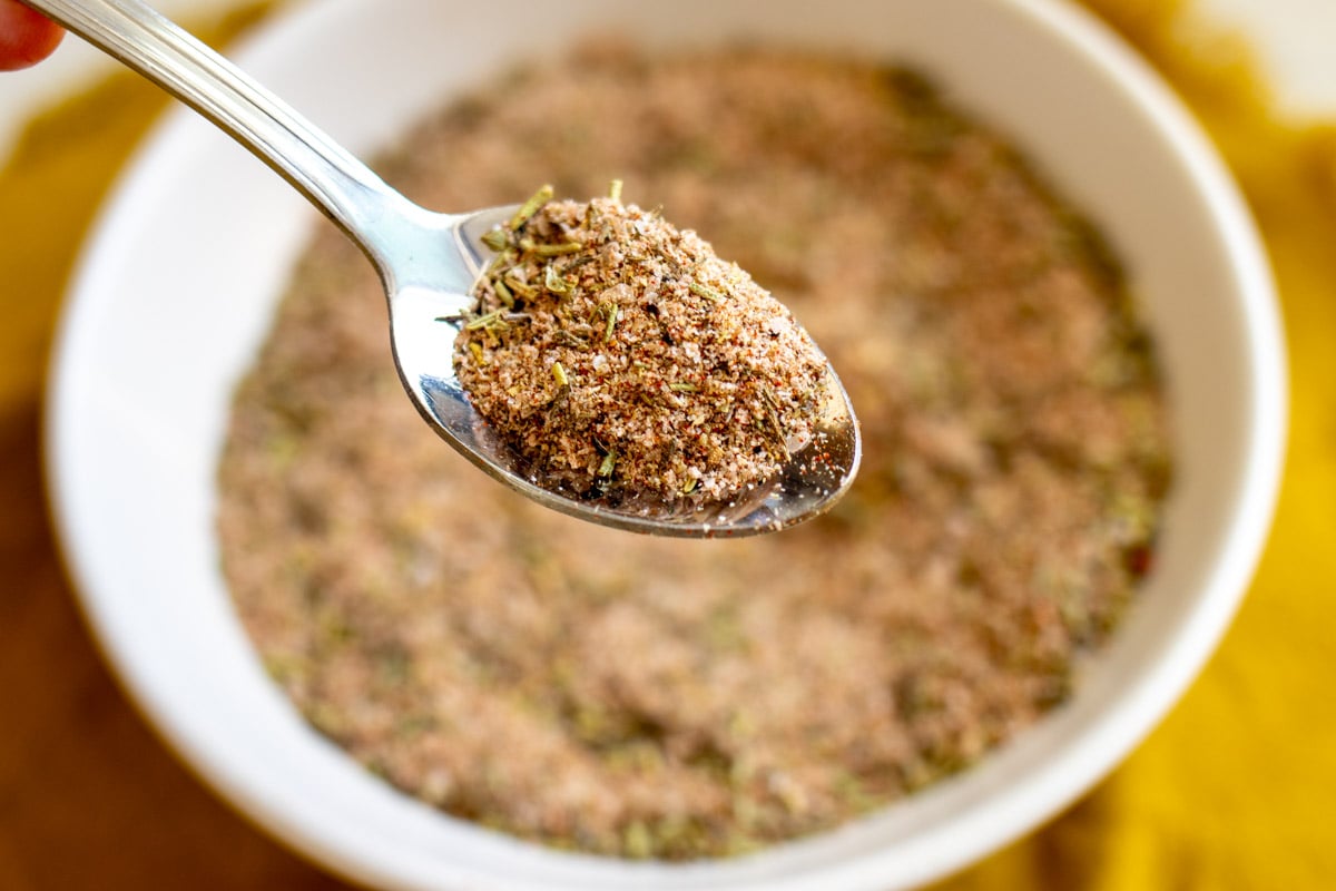 a silver spoon holding a scoop of turkey seasoning.