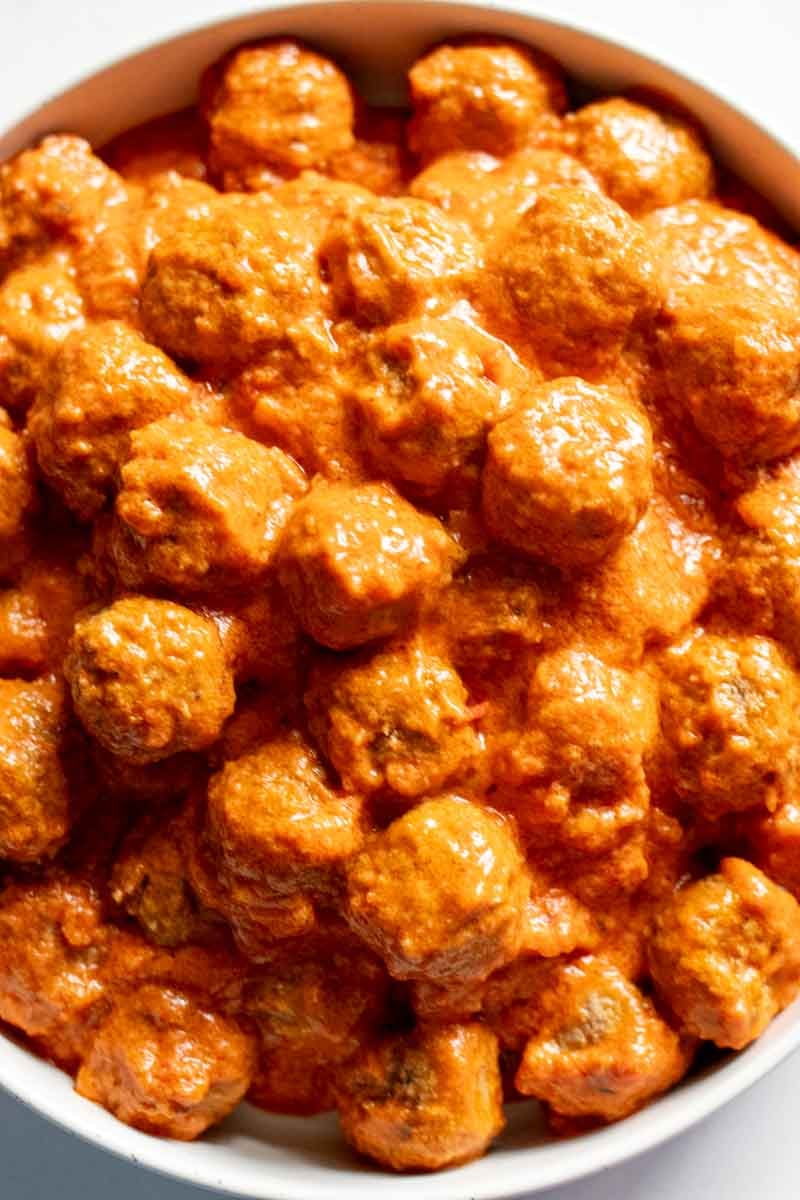 a bowl of cheesy marinara crockpot meatballs.