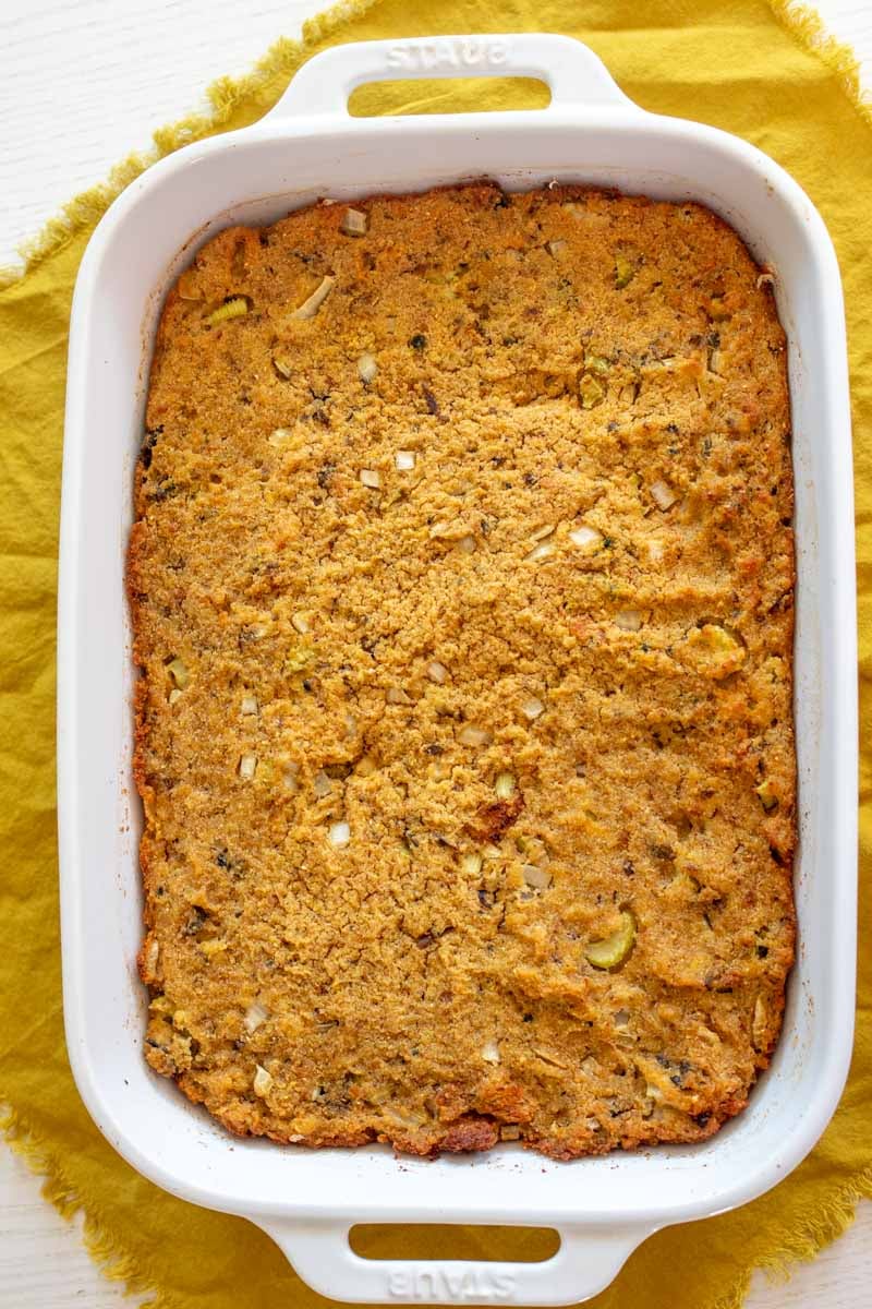 a white baking dish full of golden smoked oyster dressing.