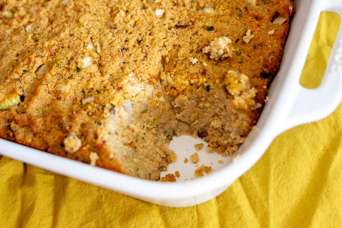 a scoop missing from a baking dish full of golden dressing that's spiked with smoked oysters.