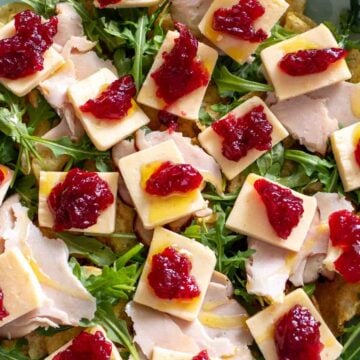 a plate of turkey cranberry and cheese charcuterie chips.