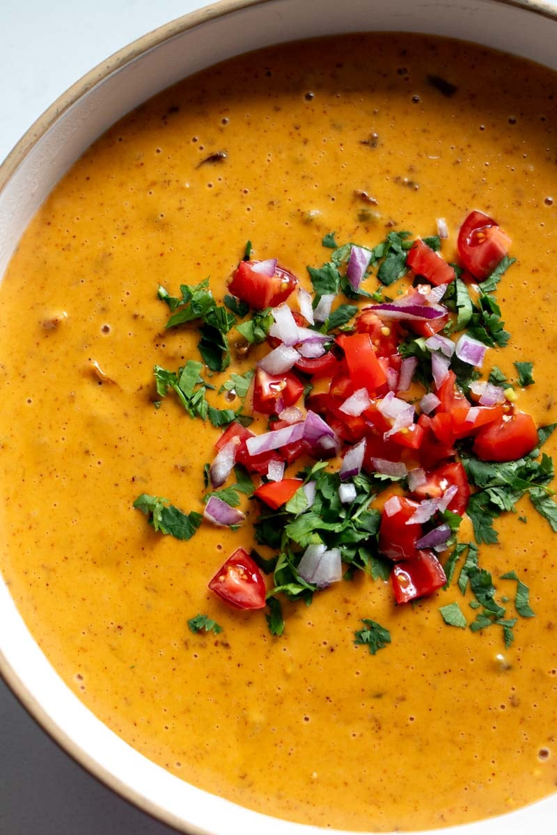 crockpot cheese dip with a green crockpot in the background.