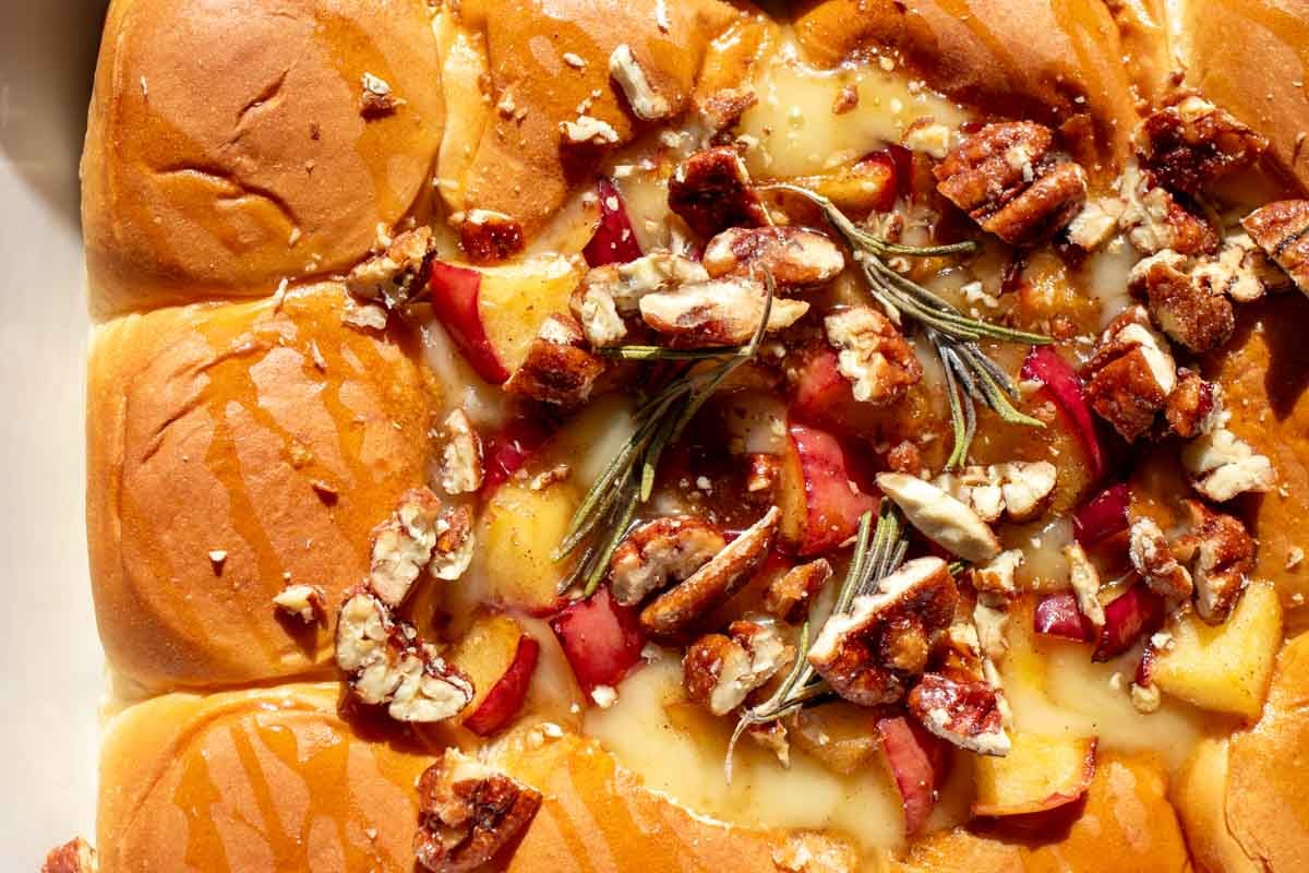 an overhead view of a big batch of hawaiian roll baked brie.