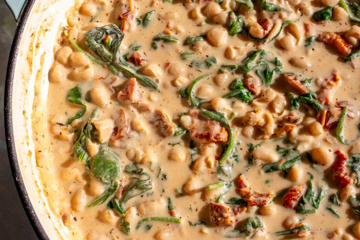 a big pot of marry me beans and all the ingredients that go with it. 