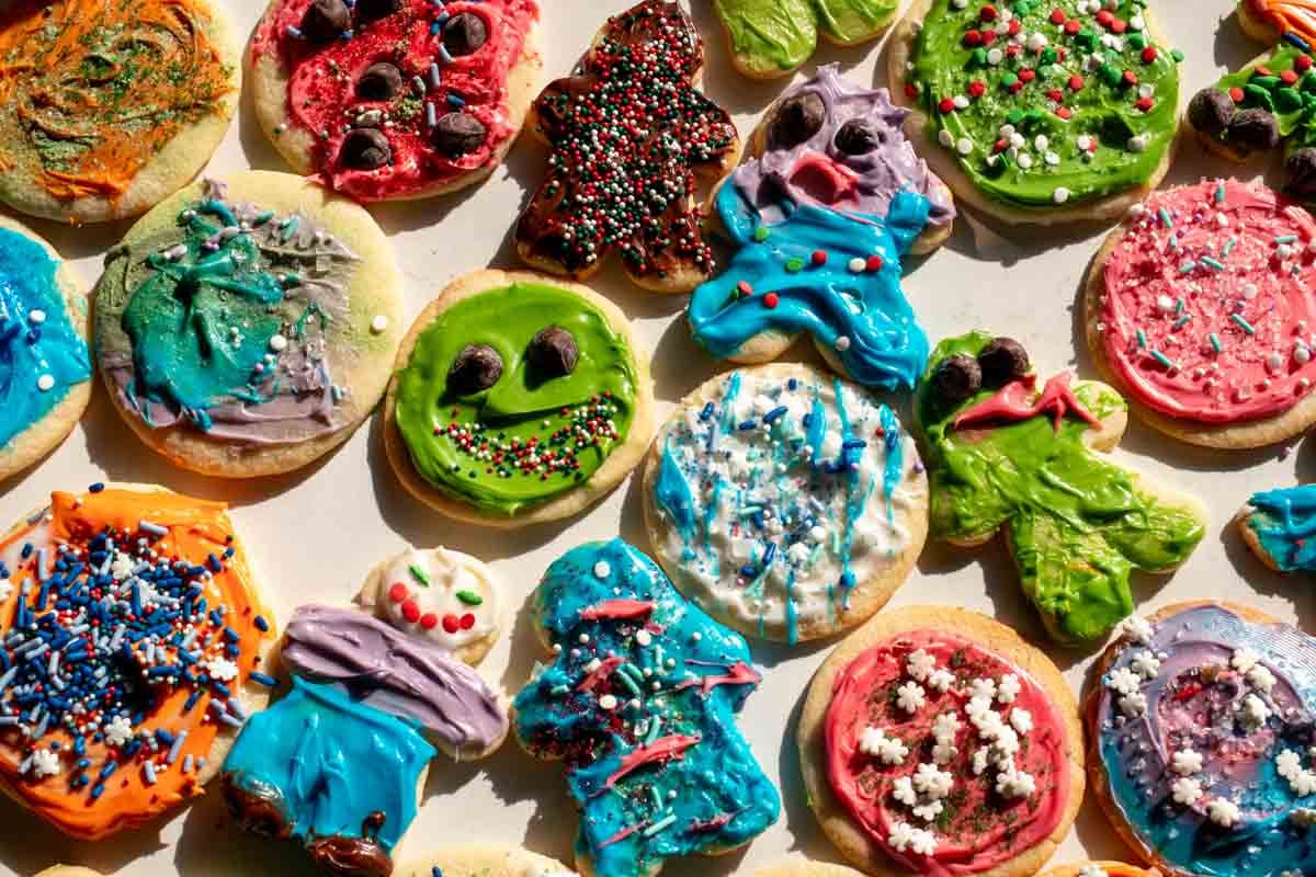 a colorful collection of decorated sugar cookies with icing, sprinkles and more.