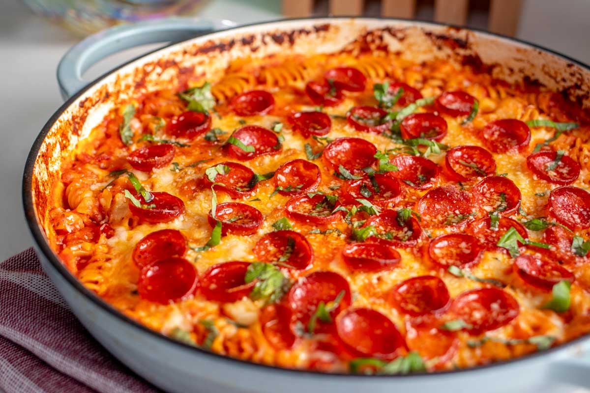 a blue baking dish full of high protein cottage cheese pizza pasta.