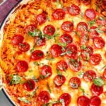a baking dish full of the viral cottage cheese pizza bowl but turned into a pasta dish using rotini pasta.
