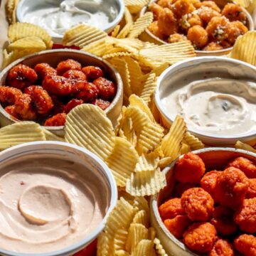 a saucy nugget platter with heluvagood dips and ridged potato chips.