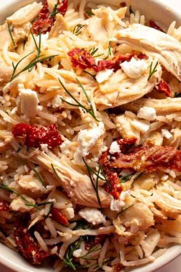 a bow lf chicken and rice with sun dried tomatoes, feta, lemon and dill using the viral shaken chicken approach.