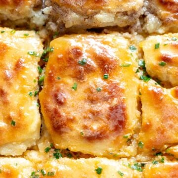 an up close look at a buttery swim biscuits with melted butter on top.