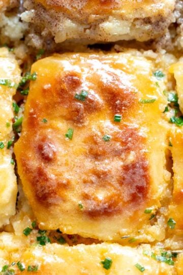 an up close look at a buttery swim biscuits with melted butter on top.