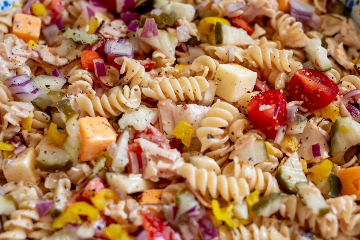 a macro view of the sub in a tub pasta salad with colorful veggies and lots of texture.