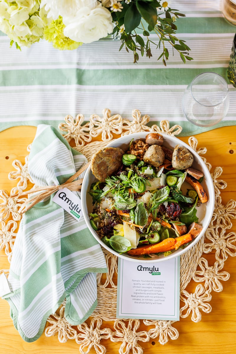 a beautiful plate of food featuring amylu's meatballs and colorful veggies.