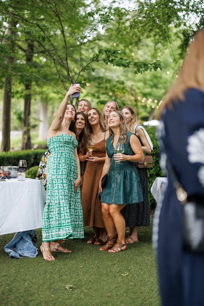 a few food bloggers taking selfies in a beautiful green lush enviroment.