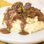 tender bites of steak in an au poivre sauce over mashed potatoes.