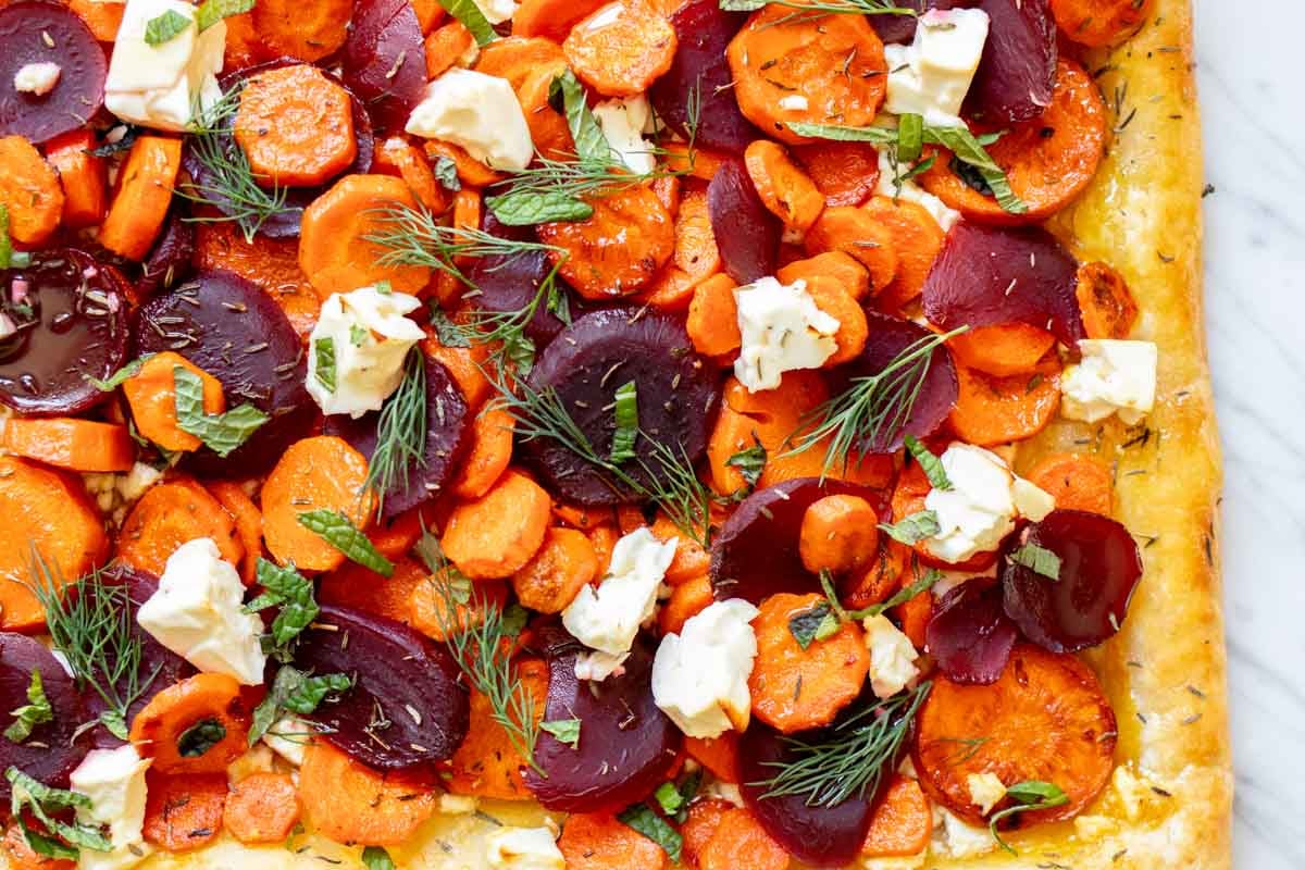 an overhead view of the texture in this carrot tart with pickled beets, feta, herbs and honey.