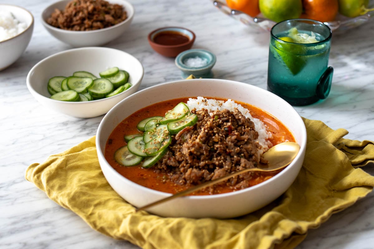 a lifestyle tablescape of these yummy broth bowls with cups and serving bowls around it.