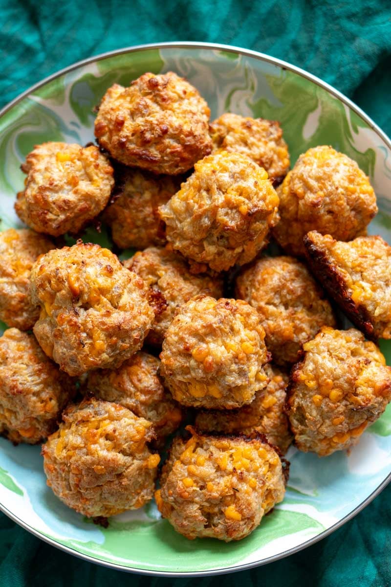 a large plate full of fall appetizes made with cheese, sausage and apple.